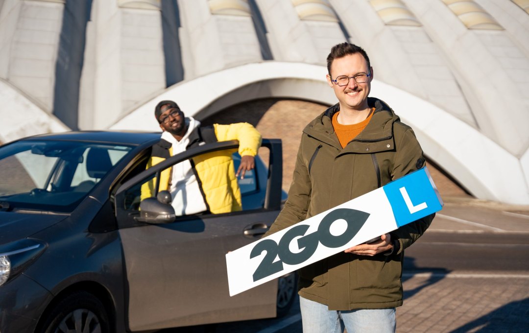 Young person and driving buddy from 2GO Lokeren with the learner car